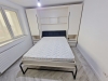 Ansamblu mobilier cu pat rabatabil și canapea, montat în Roman
